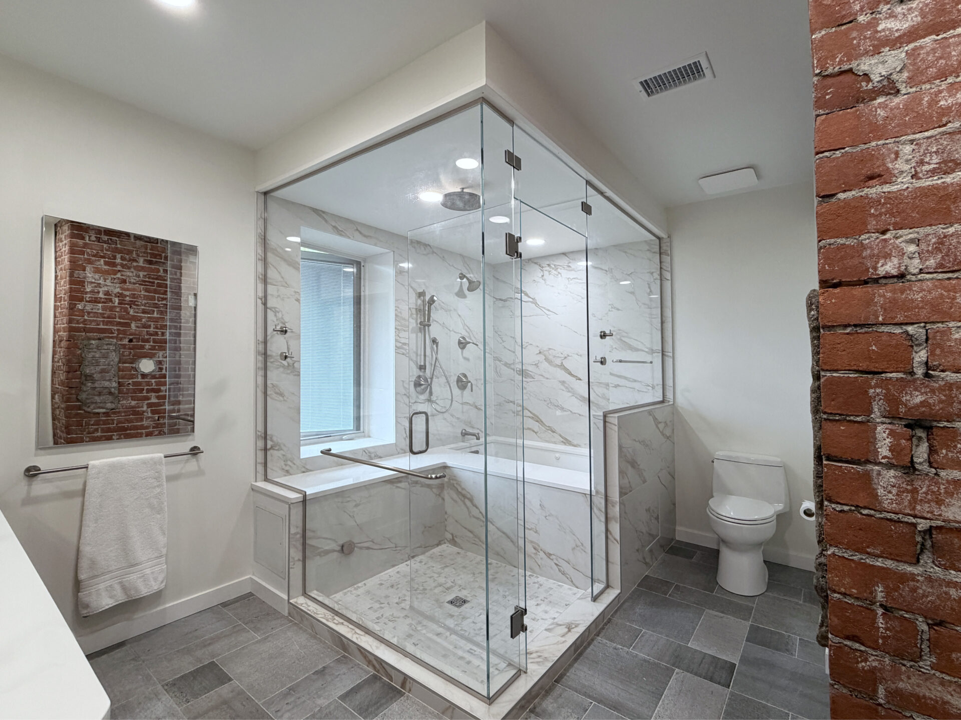 steam shower in a wet room with jacuzzi in this Historic Highland Park Home Renovation